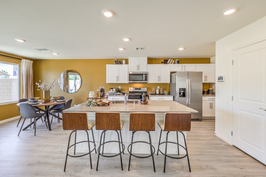 new homes for sale in north las vegas. A kitchen with an island and table with chairs. 1795 PLAN-N Las Vegas, NV