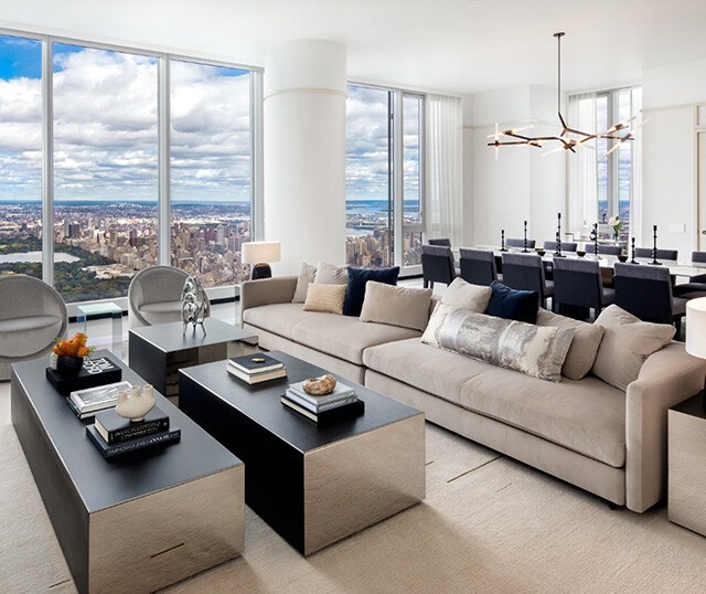 homes for sale in manhattan ny. central park tower in manhattan. A large living room with couch, two coffee tables, dining room table and more.