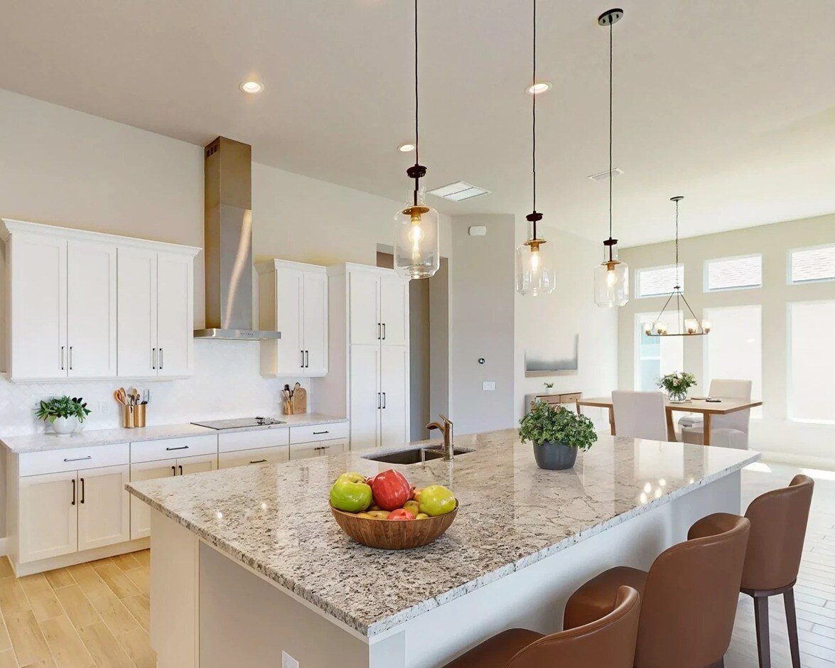 New homes in jacksonville fl. A kitchen with an island and stools. Costa Mesa-Jacksonville, FL (1)