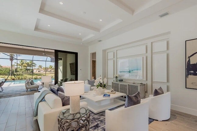 new homes in naples, fl. A living room in a new home in naples, florida with a view of the backyard.