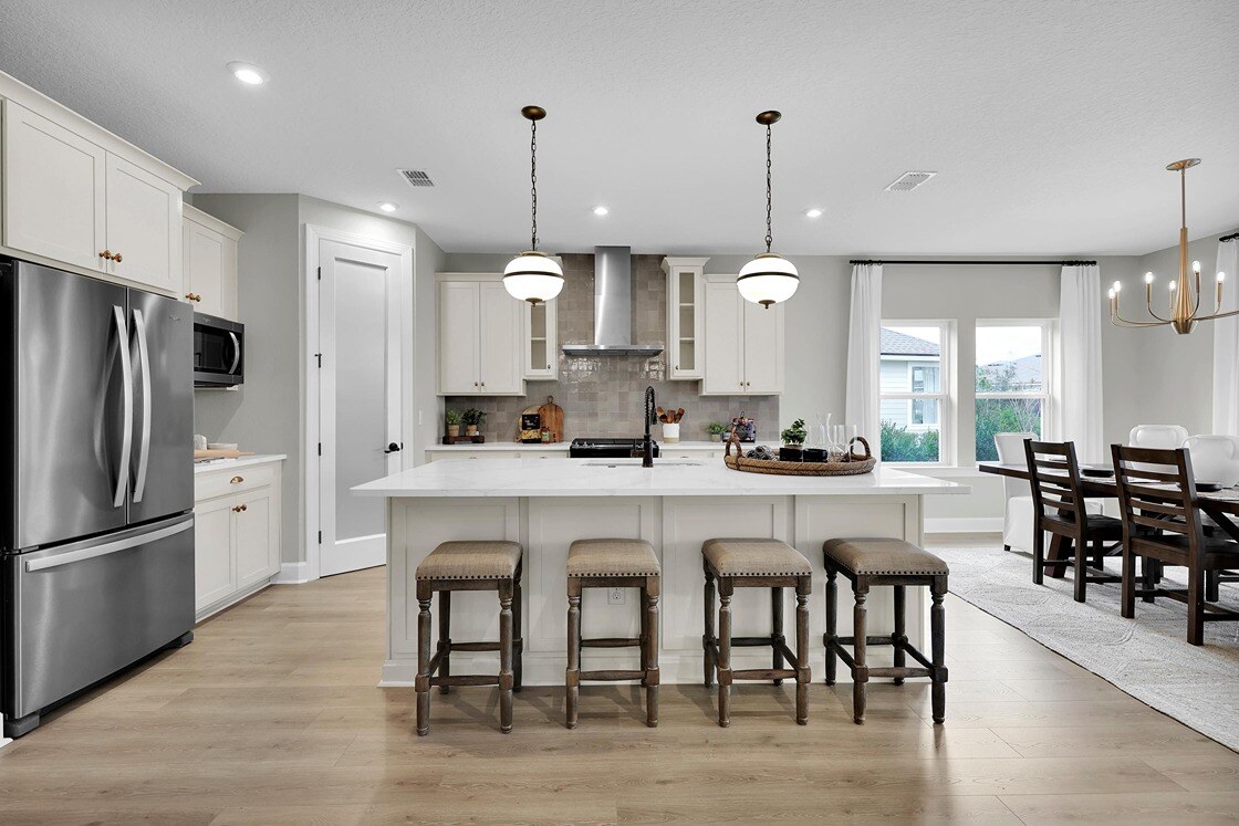 New Homes in St. Johns County, Florida. An open concept main floor showing the kitchen and dining room. Grayton II.