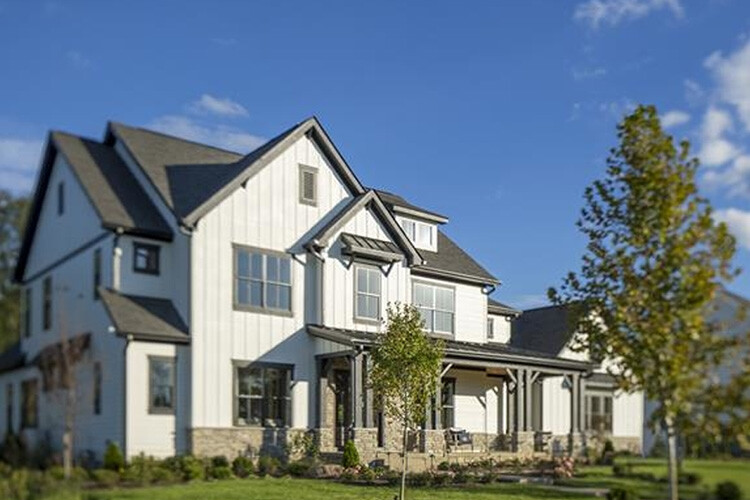 New build homes in Columbus. Jerome Village. A big house with a tree in front.