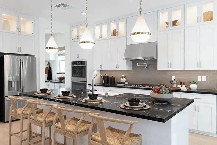 new homes in Antioch, CA. A modern kitchen with a black marble island. LEXINGTON-Antioch, CA