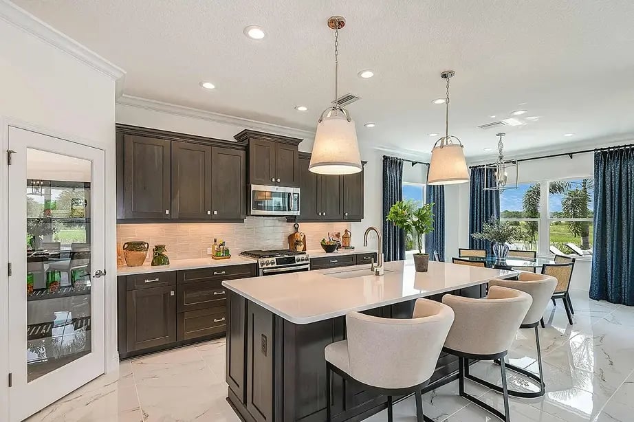 new home developments in sarasota, fl. A kitchen with the basement door and view of the outdoors in a new home.