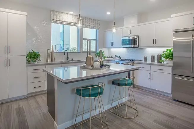 new homes in Antioch, CA. A bright kitchen with two stools at an island. PLAN 3 -Antioch, CA