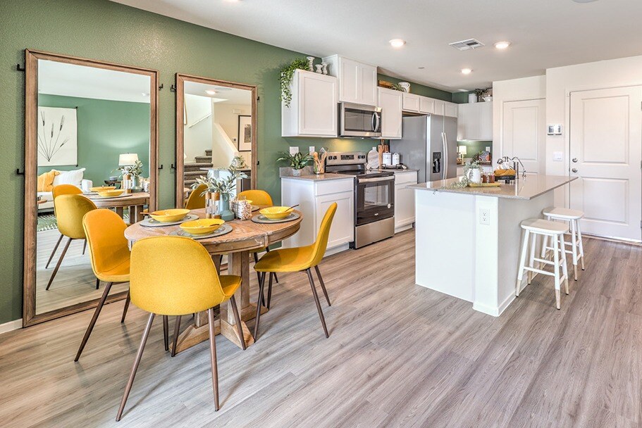 new homes for sale in north las vegas. A kitchen with a table and yellow chairs. PLAN 3 North Las Vegas, NV