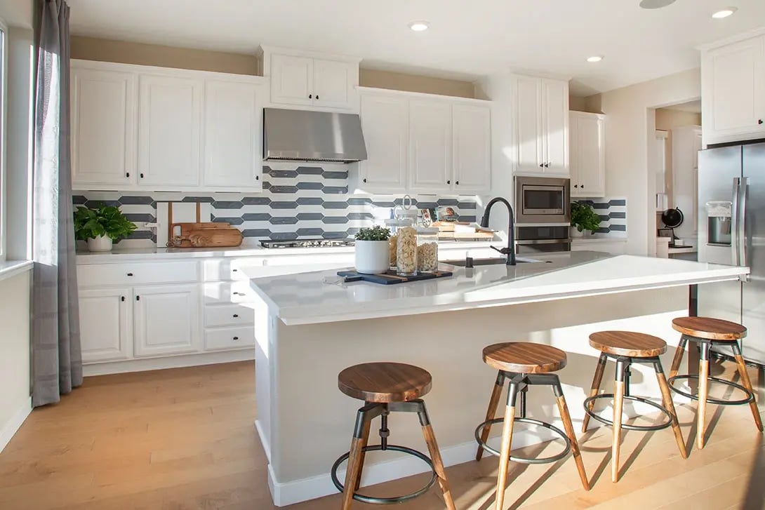 new homes in Antioch, CA. A kitchen with a white and grey backsplash. PLAN 4-Antioch, CA