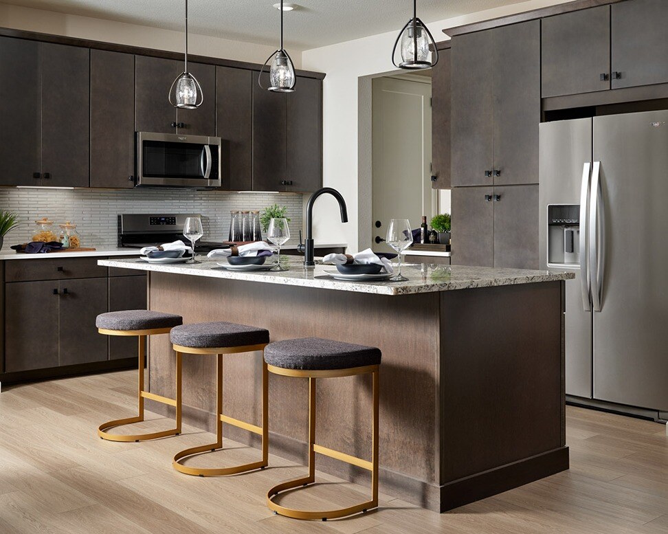 new homes for sale in denver. A kitchen with an island and three stools. Plan 3202-Denver, CO