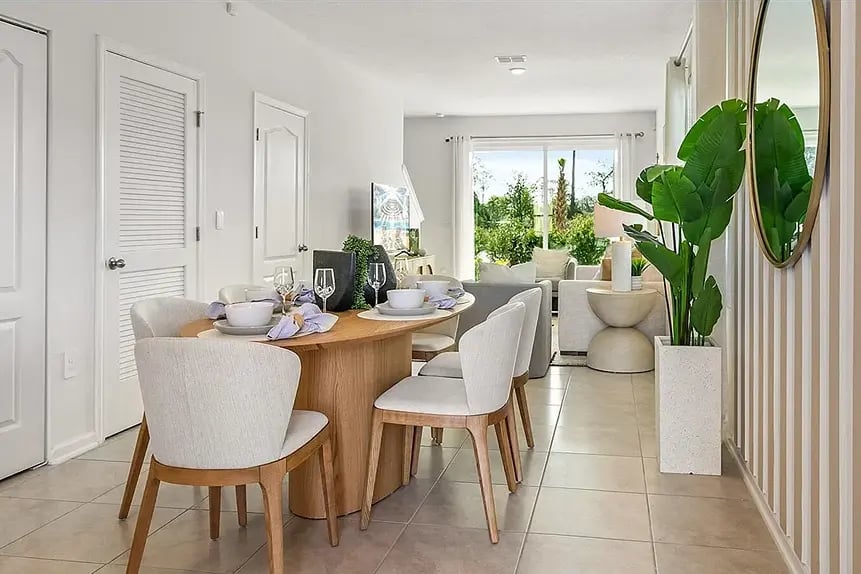 new homes in St. Augustine, FL. Side view of a dining room table with chairs and a plant. SPRINGFIELD-St Augustine, FL