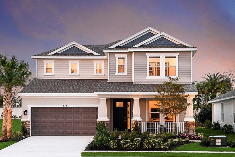 new homes in Port St. Lucie. A house with the lights on at dusk. Veranda-Oaks