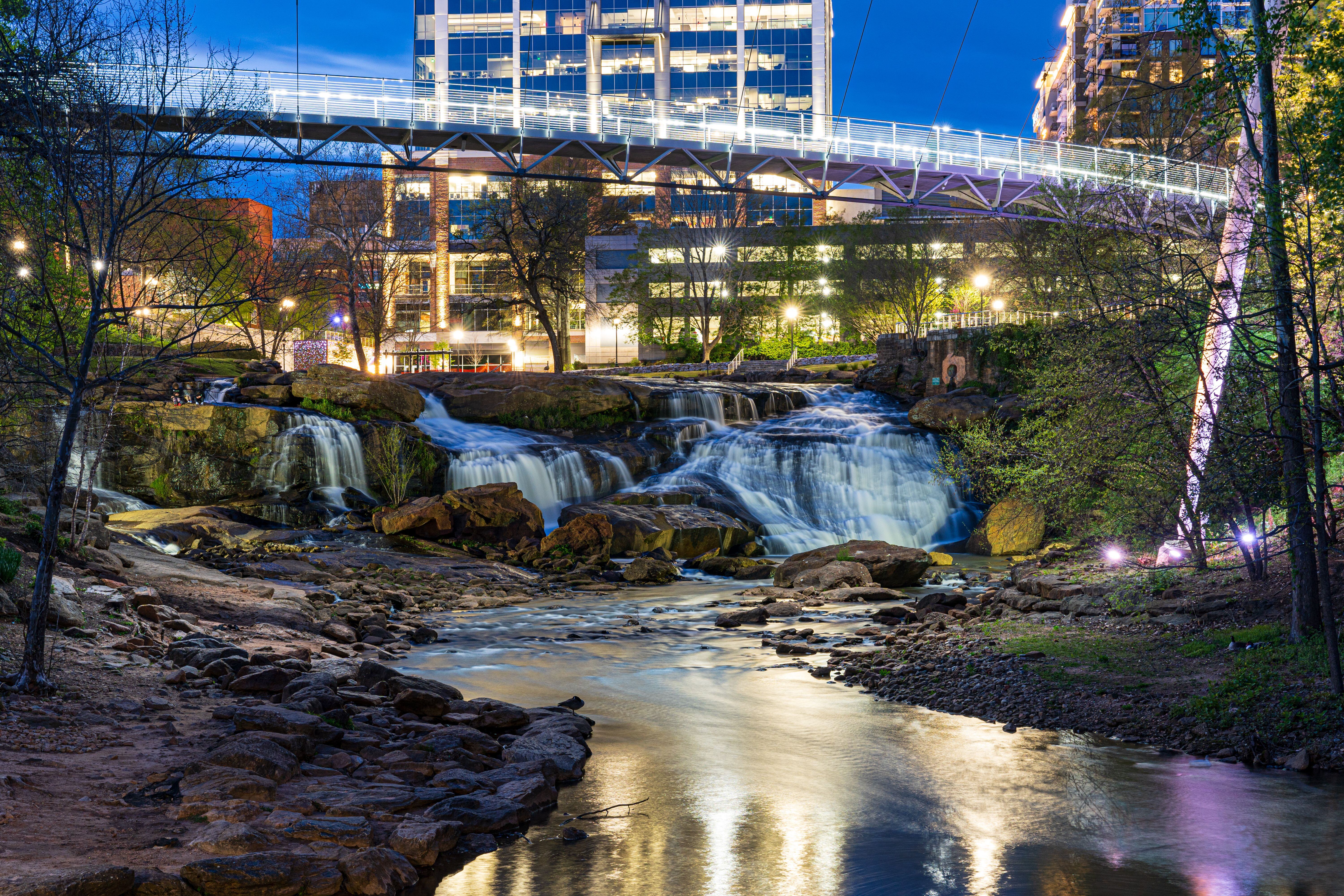 Best neighborhoods in greenville, sc. A view of liberty bridge and reedy river in Greenville.
