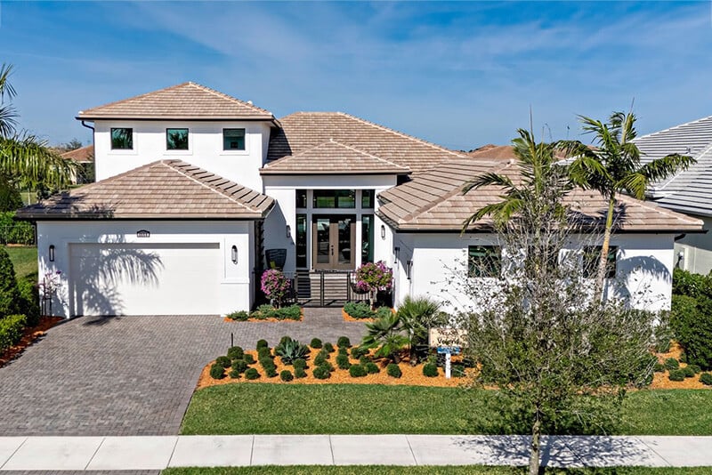 new homes in Port St. Lucie. A house with palm trees. PGA Villa Verano